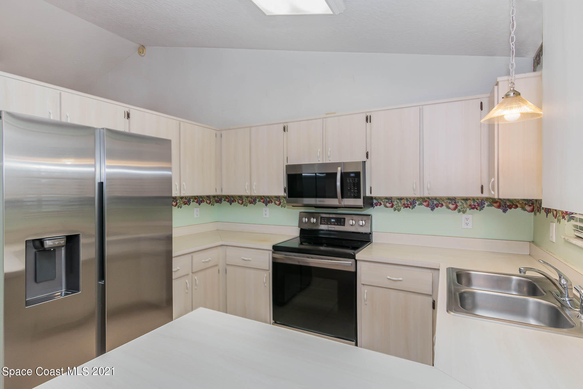 6755 Cairo Road Cocoa, FL 32927 - Photo 9 of 22 a kitchen with kitchen island granite countertop stainless steel appliances and sink