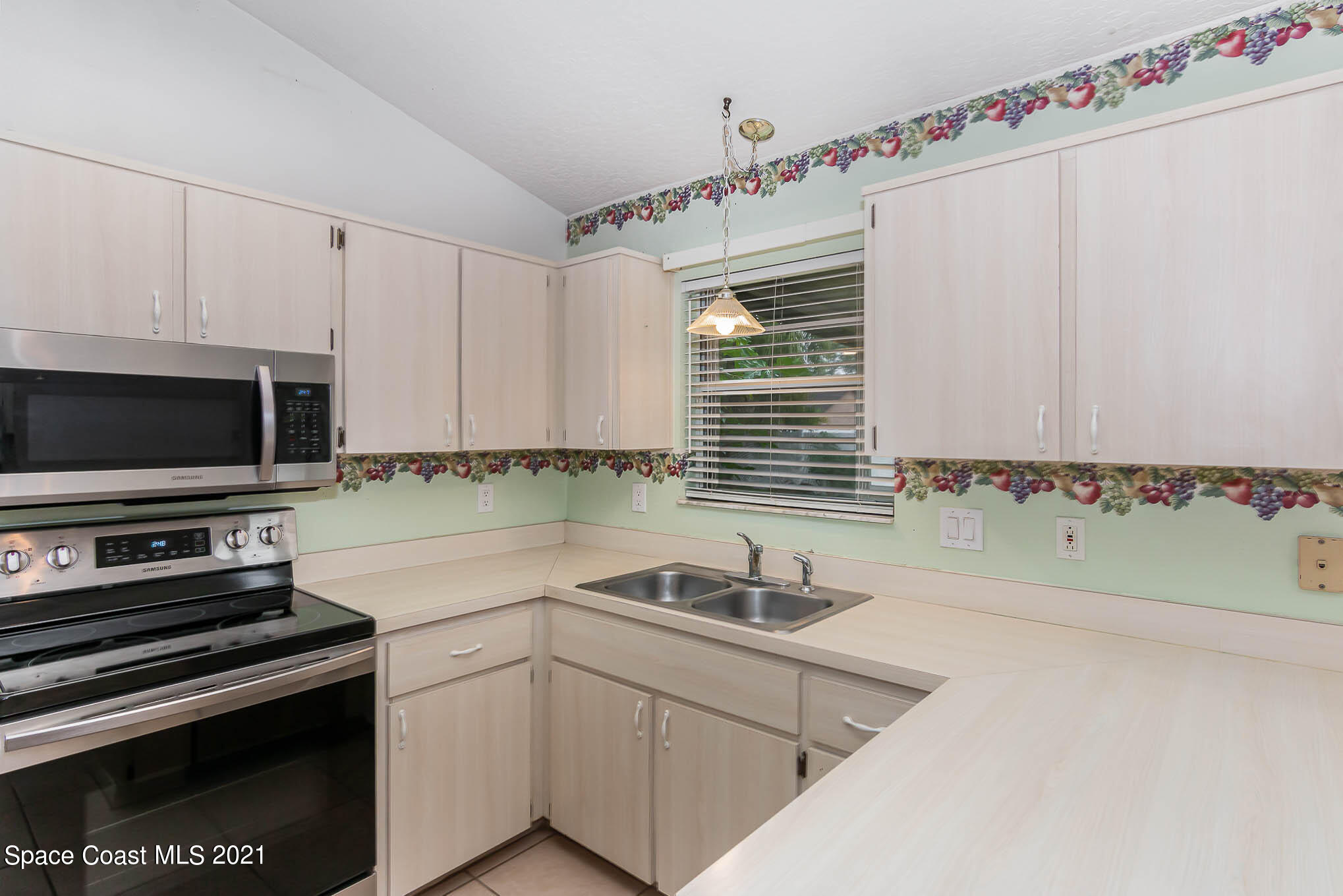 6755 Cairo Road Cocoa, FL 32927 - Photo 10 of 22 a kitchen with stainless steel appliances a sink dishwasher a stove and a microwave