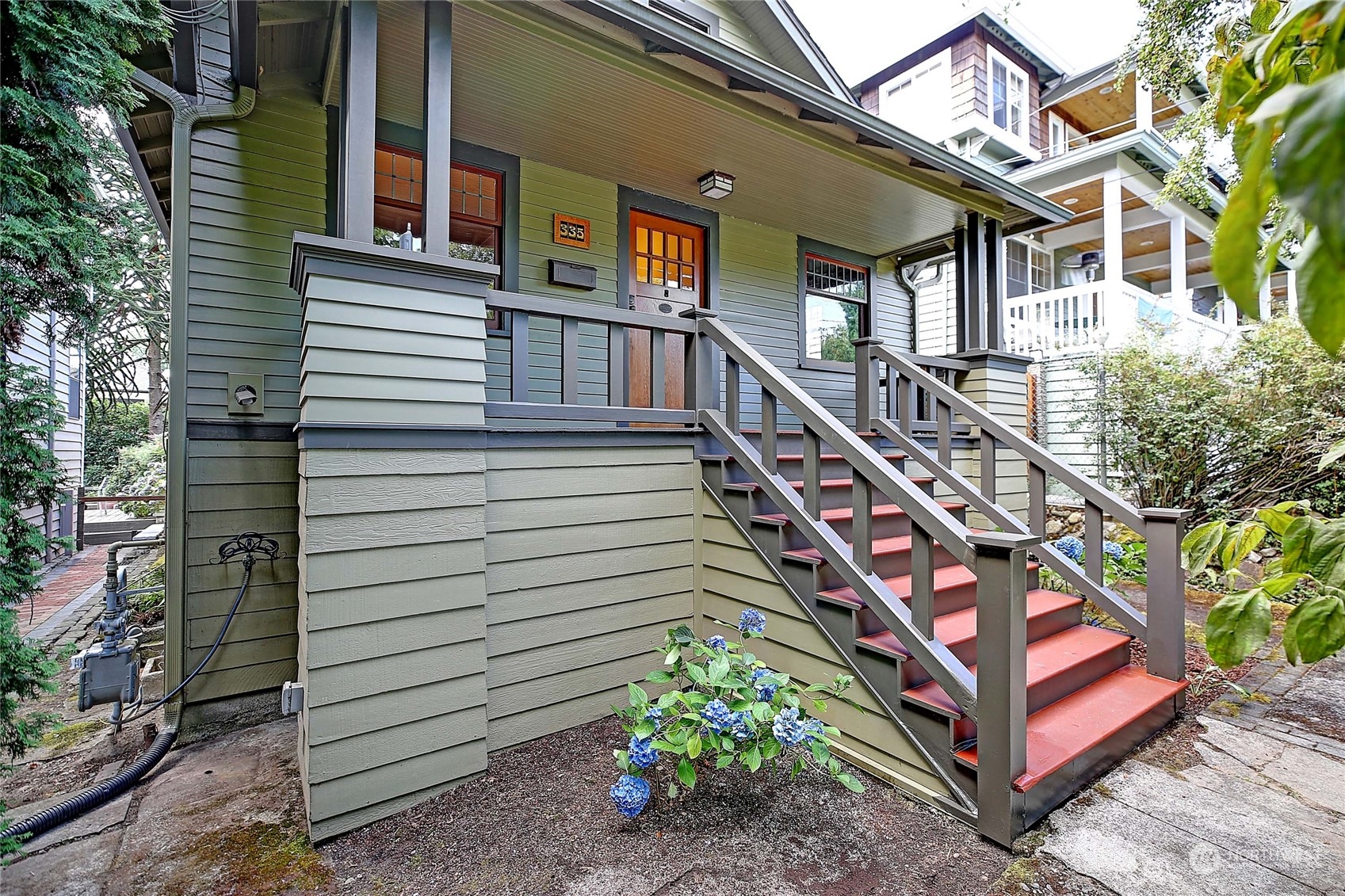 335 North 77th Street Seattle, WA 98103 - Photo 4 of 36 a view of a house with a yard and stairs