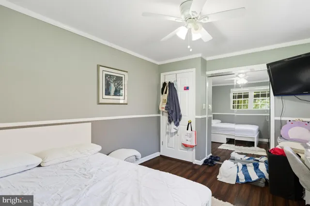 a bedroom with furniture and a flat screen tv