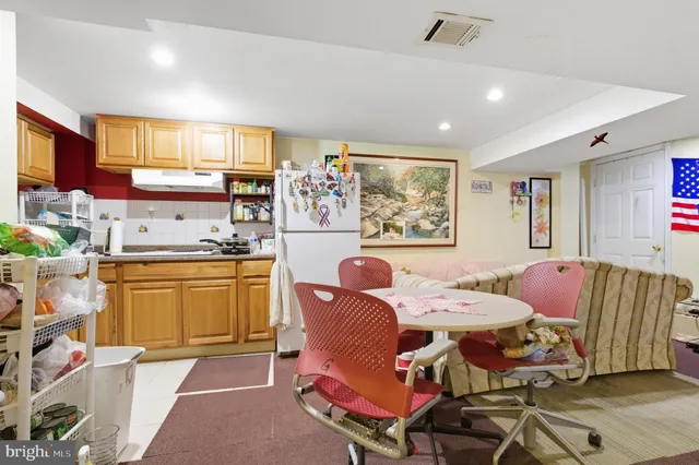 a living room with furniture and kitchen view