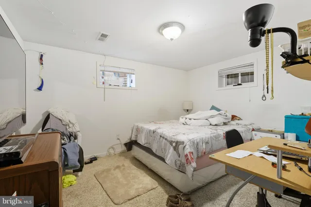 a bed room with a bed and a desk