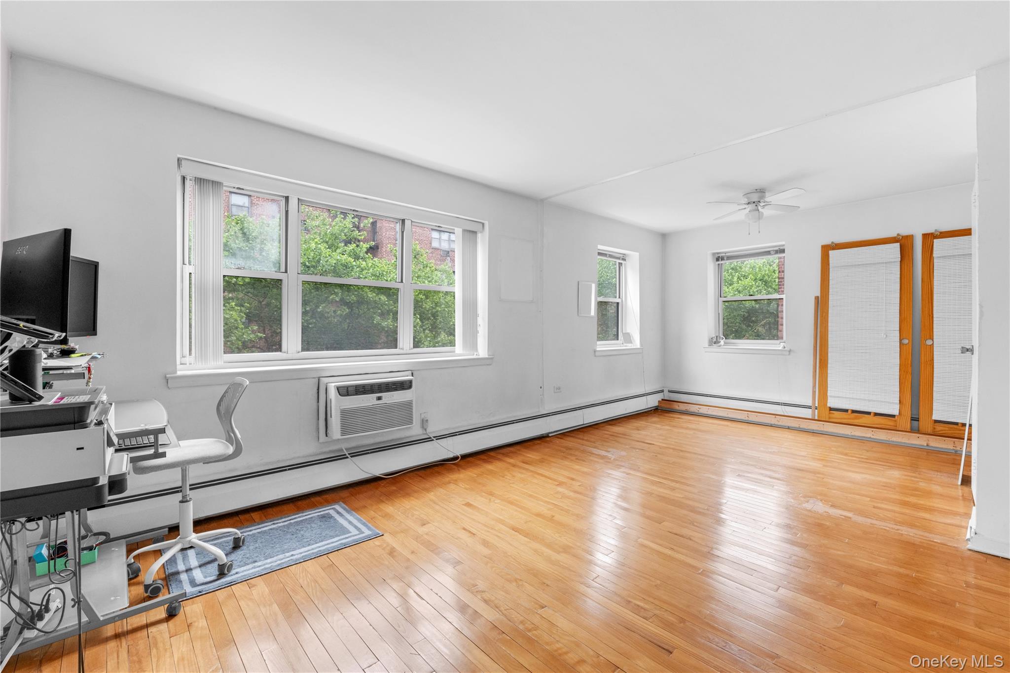 99-10 60th Avenue, Unit 3B Queens, NY 11368 - Photo 10 of 27 a living room with fireplace furniture and a large window