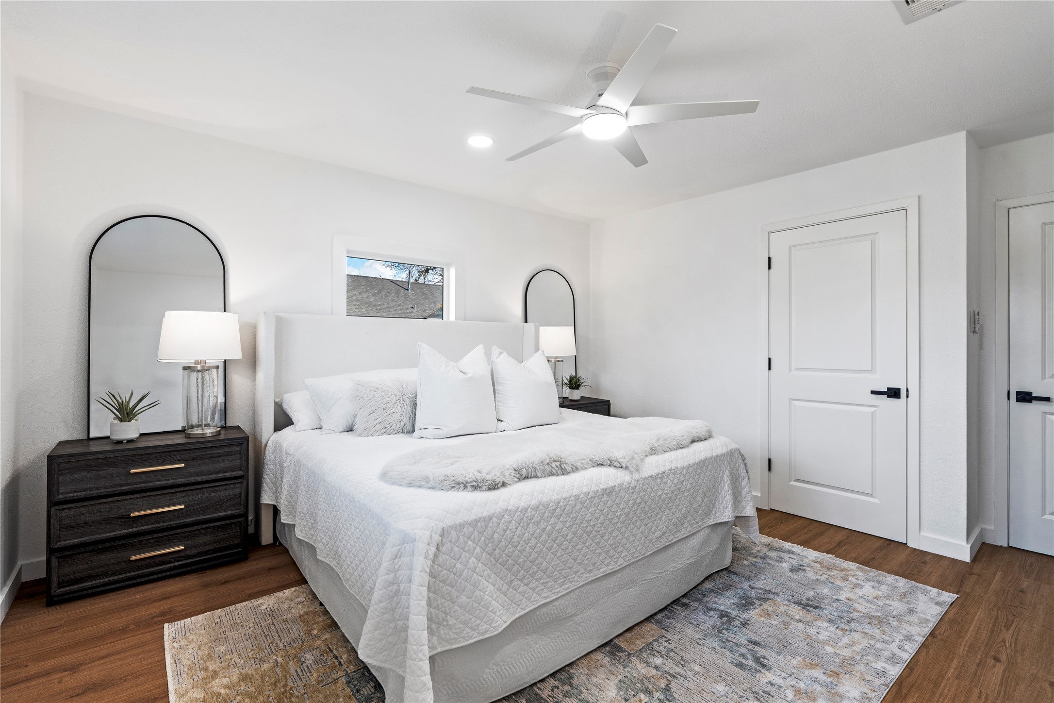 5023 Redstart Street Houston, TX 77035 - Photo 24 of 34 This bright and spacious primary suite offers a peaceful atmosphere with warm wood-style flooring and large windows that invite in natural light.