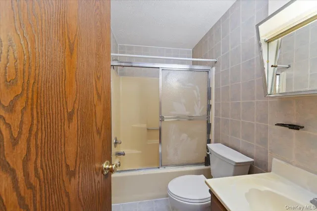 a bathroom with a toilet a sink and shower