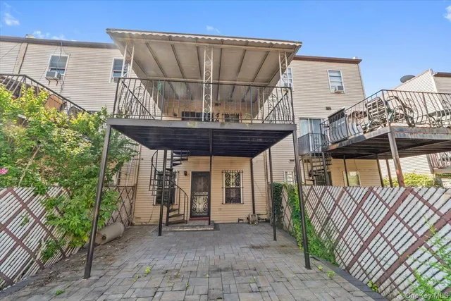 a view of a porch with furniture and floor to ceiling window