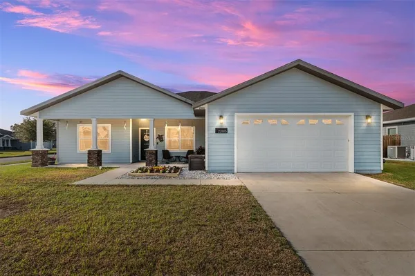a front view of house with yard patio and glass windows