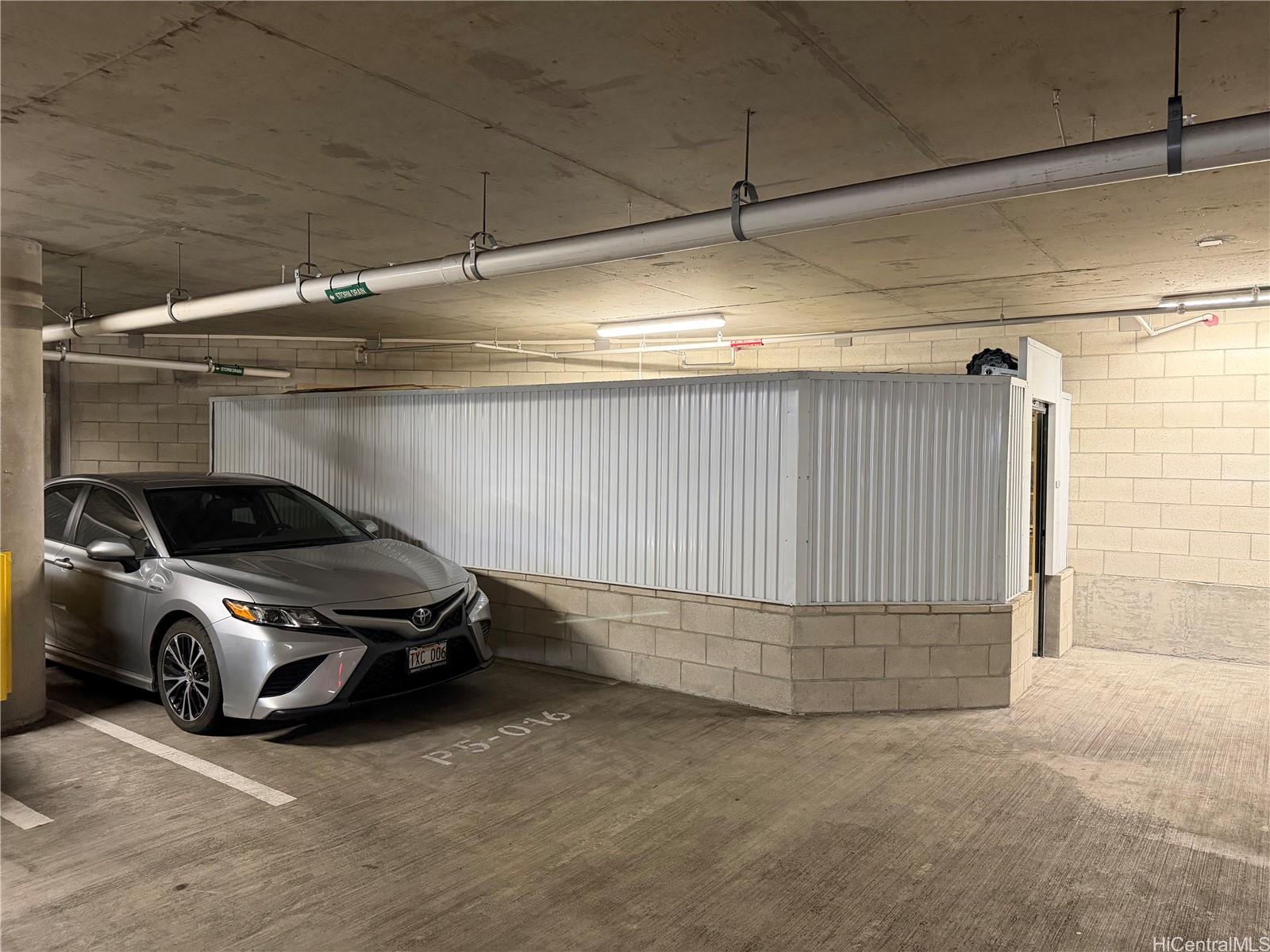 1001 Queen Street, Unit S516 Honolulu, HI 96814 - Photo 1 of 2 a car parked in a garage