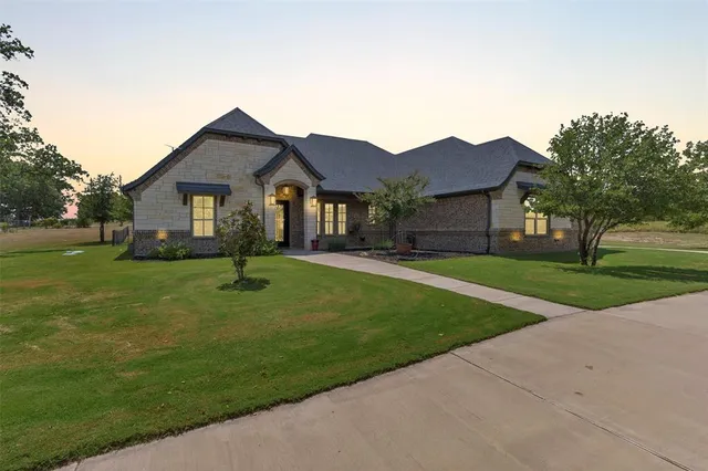 a front view of house with yard and green space