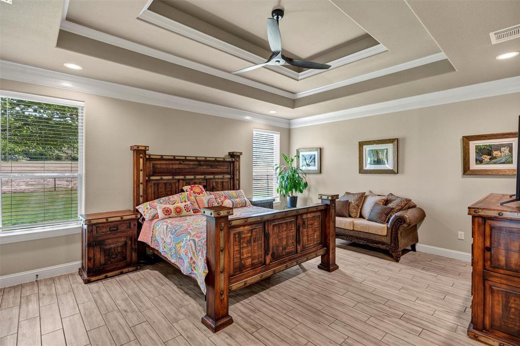 4030 Neri Oaks Court Granbury, TX 76048 - Photo 19 of 40 a bed room with a bed and a couch