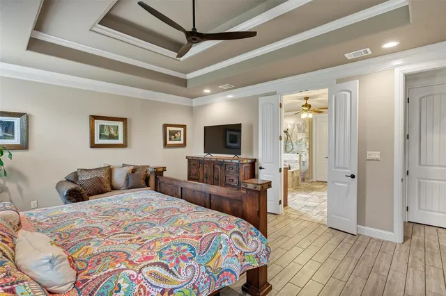 a bedroom with a large bed and a flat screen tv