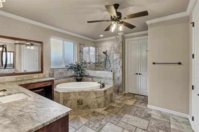 a bathroom with a granite countertop sink a toilet a mirror and shower