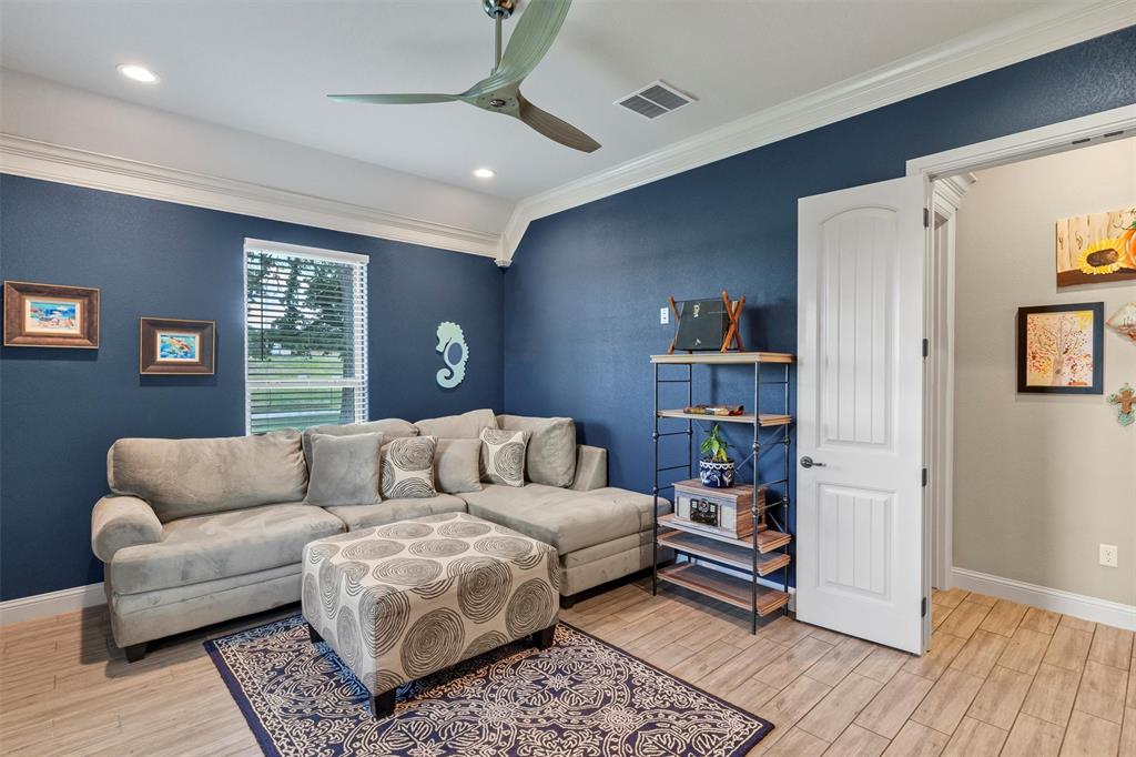 4030 Neri Oaks Court Granbury, TX 76048 - Photo 27 of 40 a living room with furniture and a book shelf