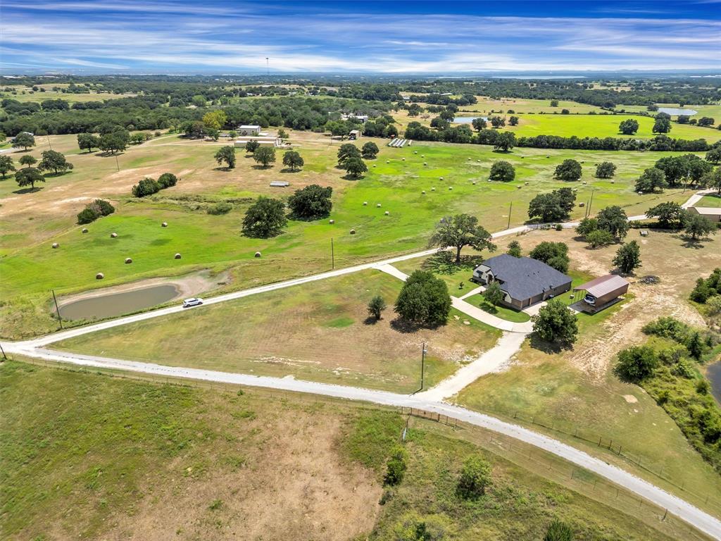 4030 Neri Oaks Court Granbury, TX 76048 - Photo 40 of 40 a view of a swimming pool of a building with a yard