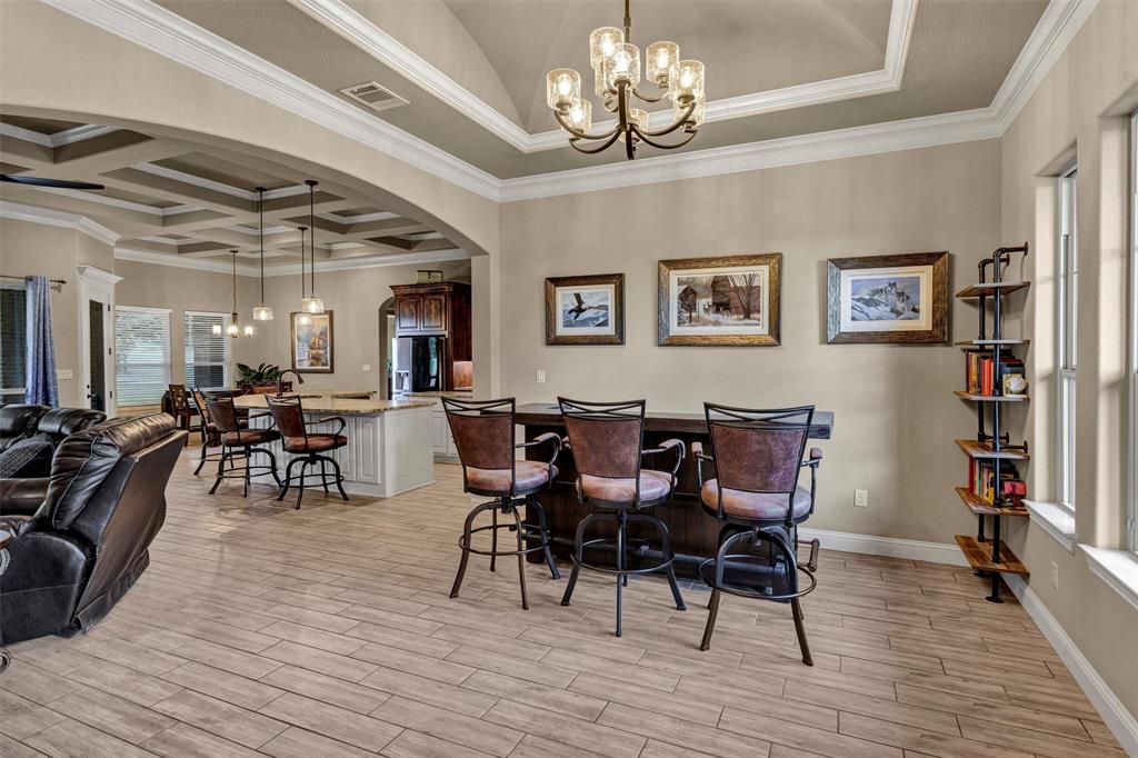 4030 Neri Oaks Court Granbury, TX 76048 - Photo 8 of 40 a view of a dining room with furniture and wooden floor