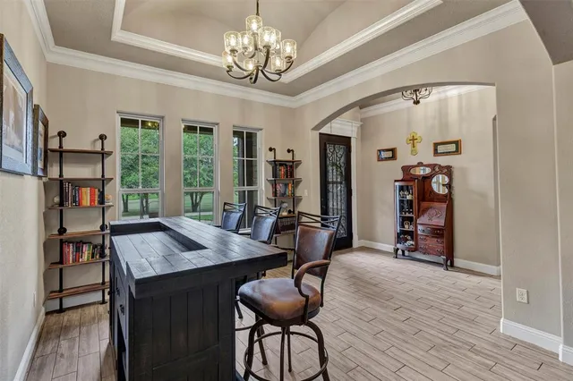 a view of a room with furniture and a chandelier