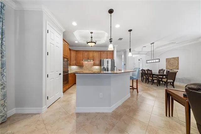 a view of kitchen with furniture and living room