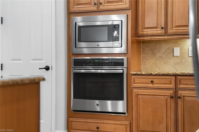 a stove top oven sitting inside of a kitchen
