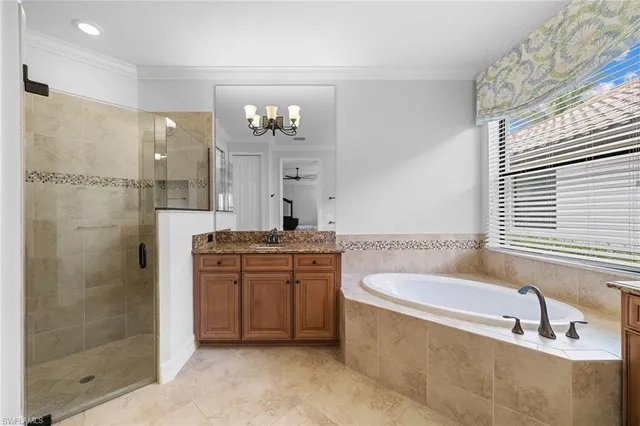 a bathroom with a granite countertop bathtub shower sink and mirror