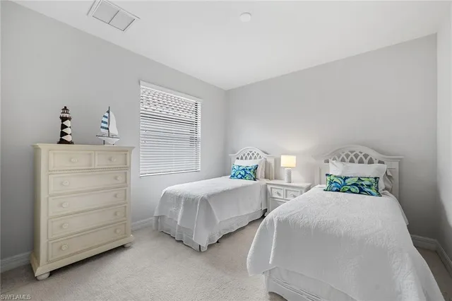 a bedroom with two beds and two dressers