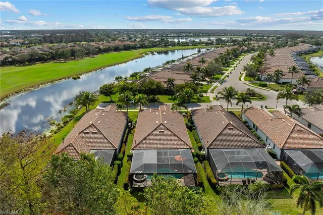 an aerial view of a house with a yard and lake view