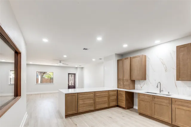 a large bathroom with a sink mirror and a bathtub