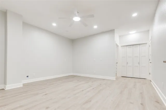 an empty room with wooden floor and white walls