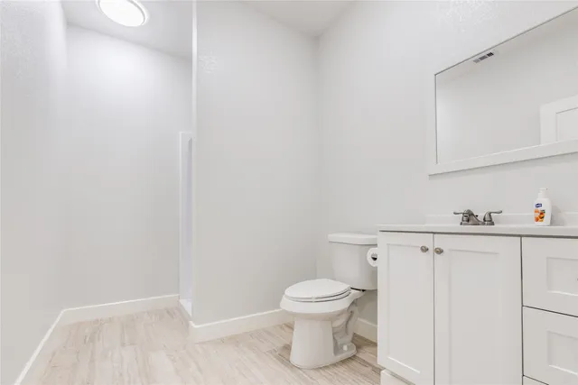 a white toilet sitting next to a bathroom sink