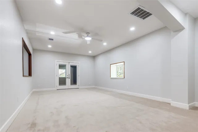 an empty room with windows and closet