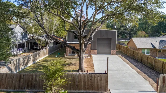 an aerial view of a house with a yard and lake view
