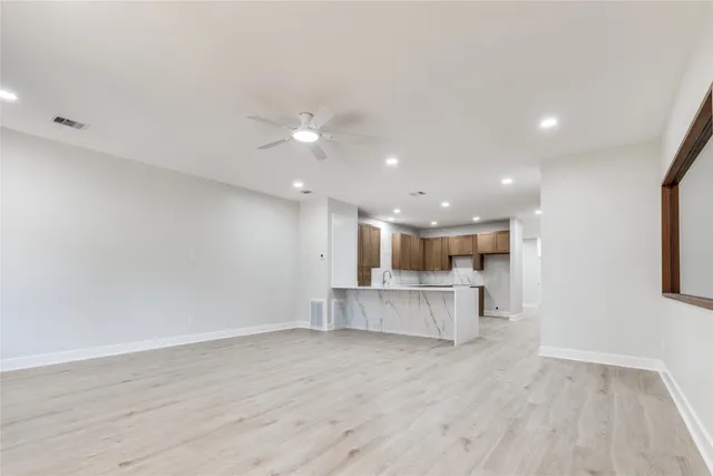 a view of kitchen with kitchen island and stainless steel appliances