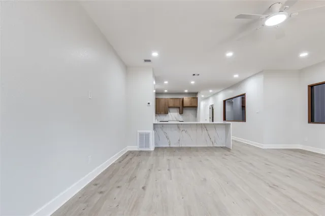 a view of kitchen with cabinets and wooden floor