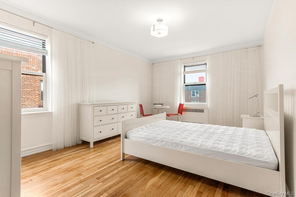 100-10 67th Road, Unit 6L Queens, NY 11375 - Photo 19 of 26 a bedroom with a bed and a window