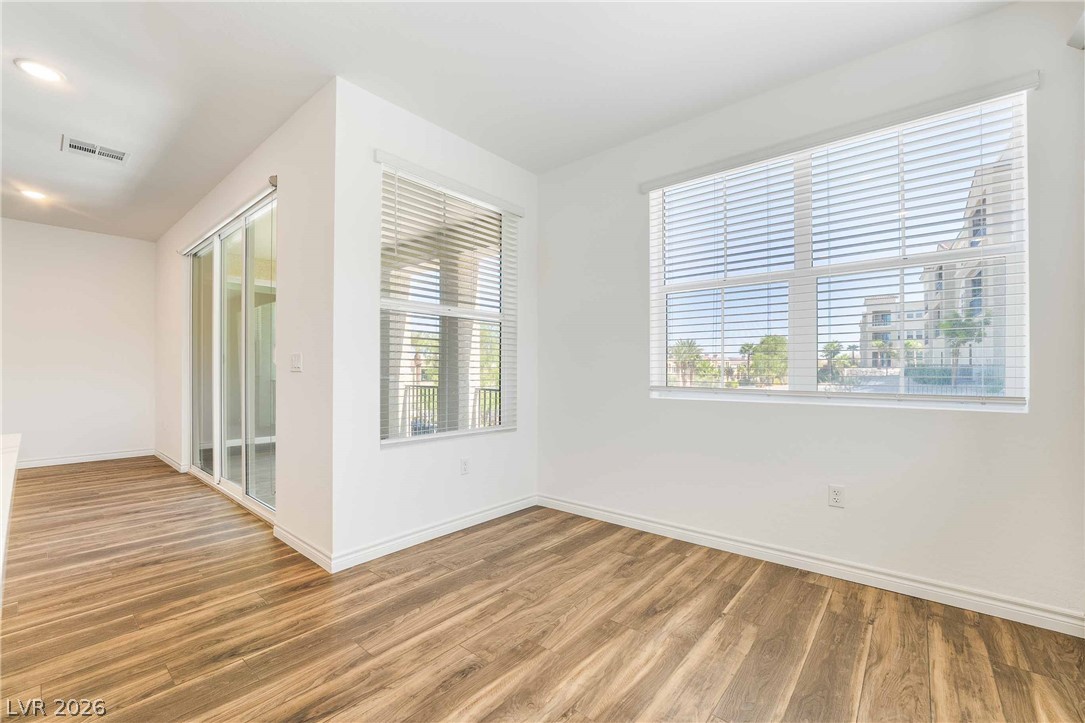 2555 Hampton Road, Unit 10202 Henderson, NV 89052 - Photo 15 of 35 Warm wood flooring pairs with abundant natural light from large windows and sliding glass doors.