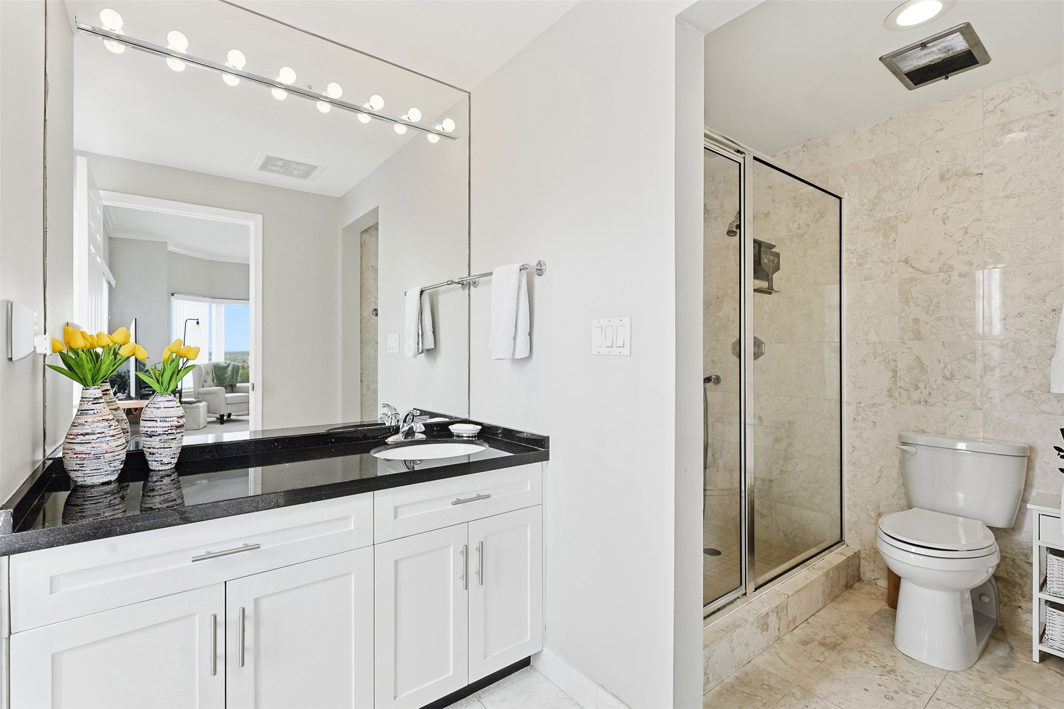 2001 Holcombe Boulevard, Unit 1106 Houston, TX 77030 - Photo 11 of 50 The primary bathroom features white cabinetry, neutral tile and a standing shower.