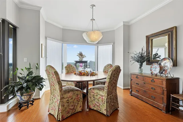 a dining room with furniture and wooden floor