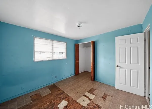 a view of a room with wooden floor and windows