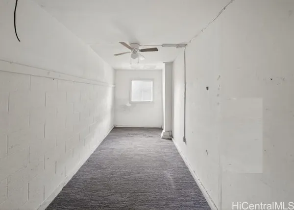 a view of a hallway with white walls
