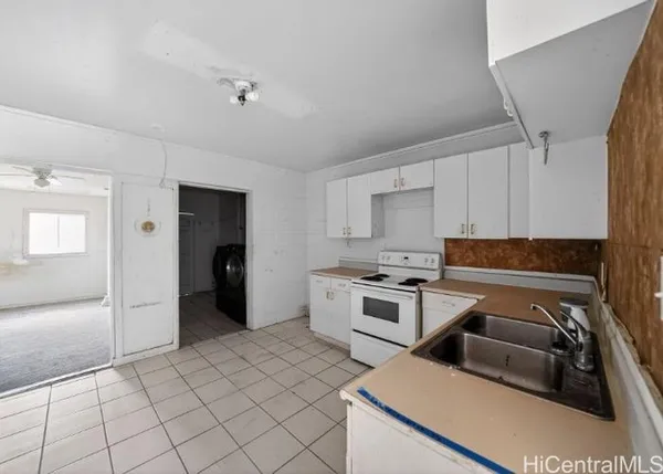a kitchen with a stove a refrigerator and cabinets