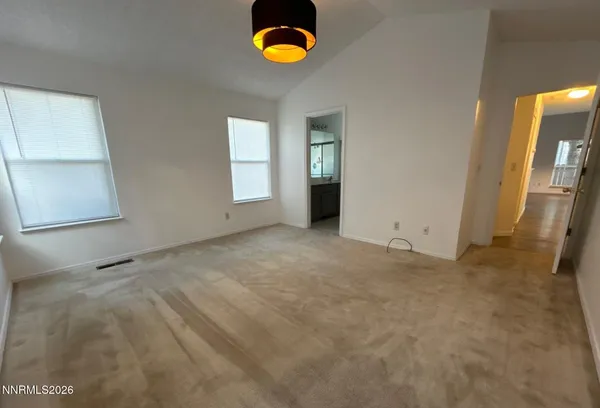 a view of an empty room with windows