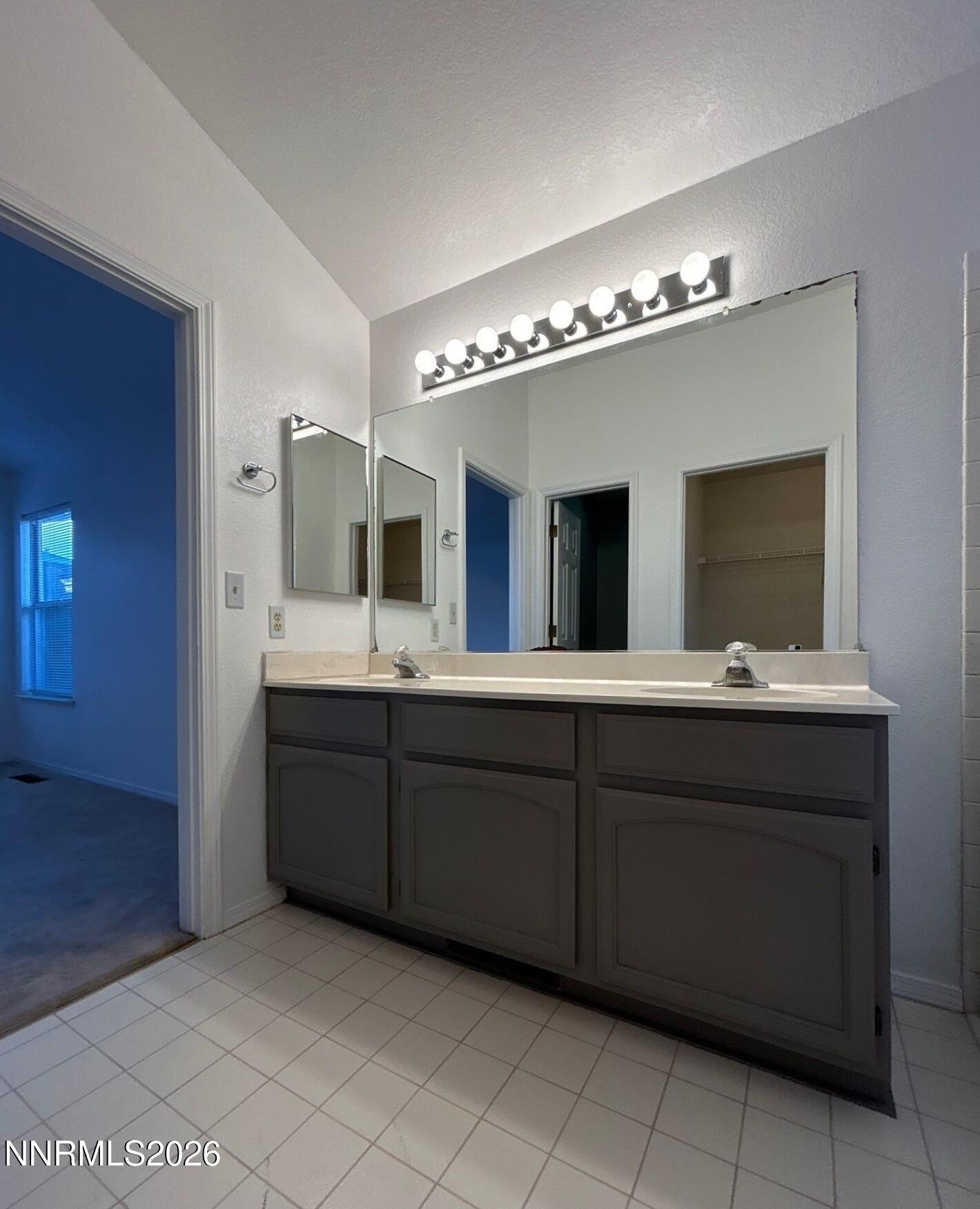 4771 Amber Hill Lane Reno, NV 89523 - Photo 15 of 20 a spacious bathroom with a double vanity sink and a mirror