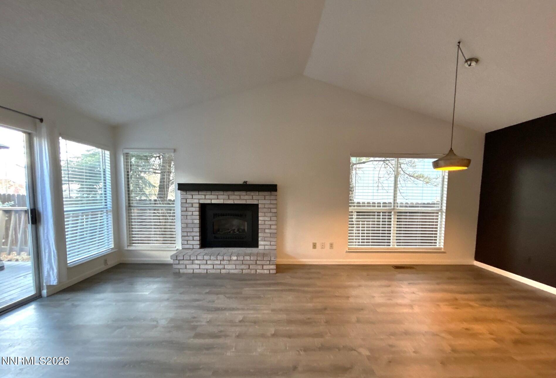 4771 Amber Hill Lane Reno, NV 89523 - Photo 3 of 20 a view of an empty room with wooden floor and a window