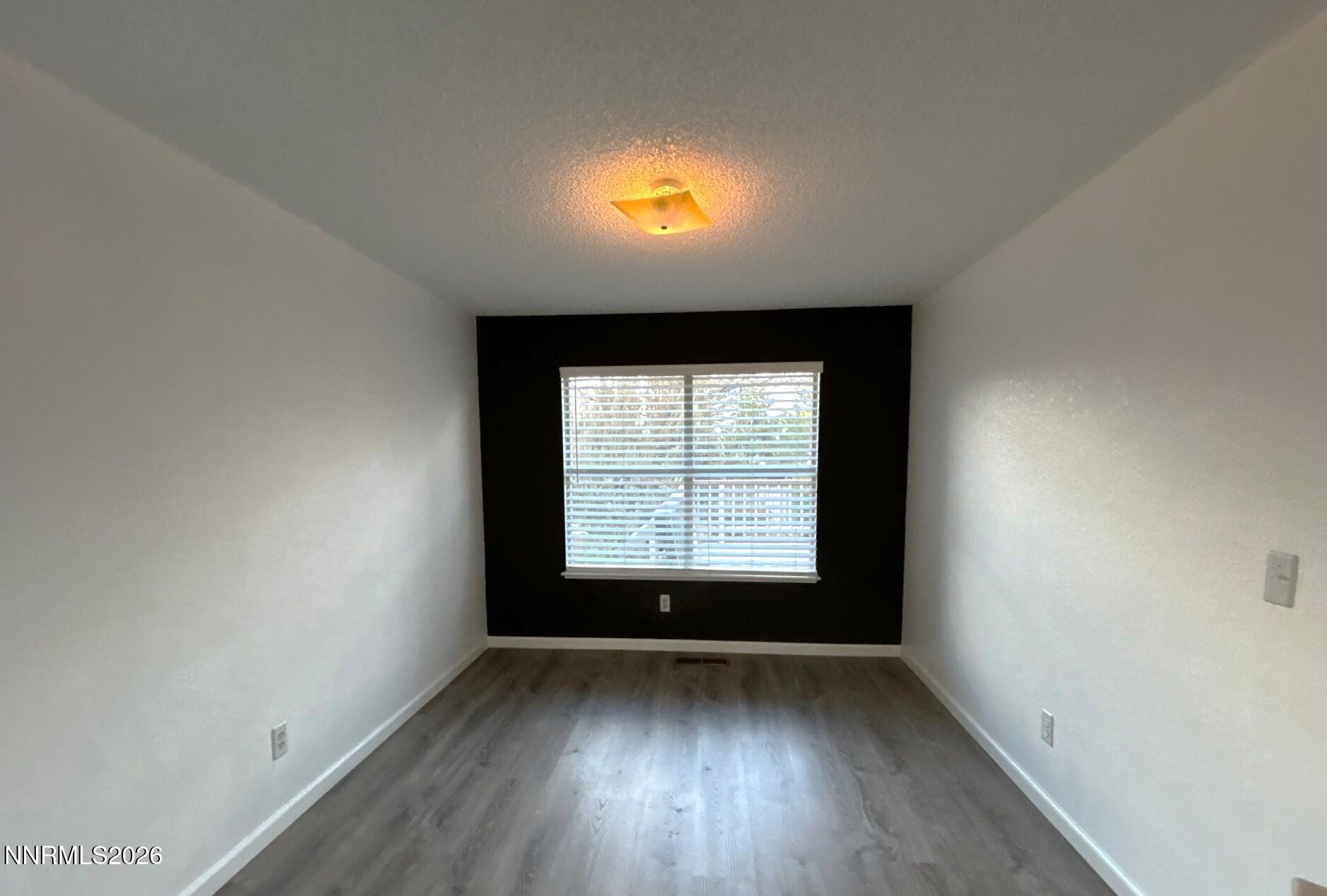 4771 Amber Hill Lane Reno, NV 89523 - Photo 8 of 20 an empty room with wooden floor and windows
