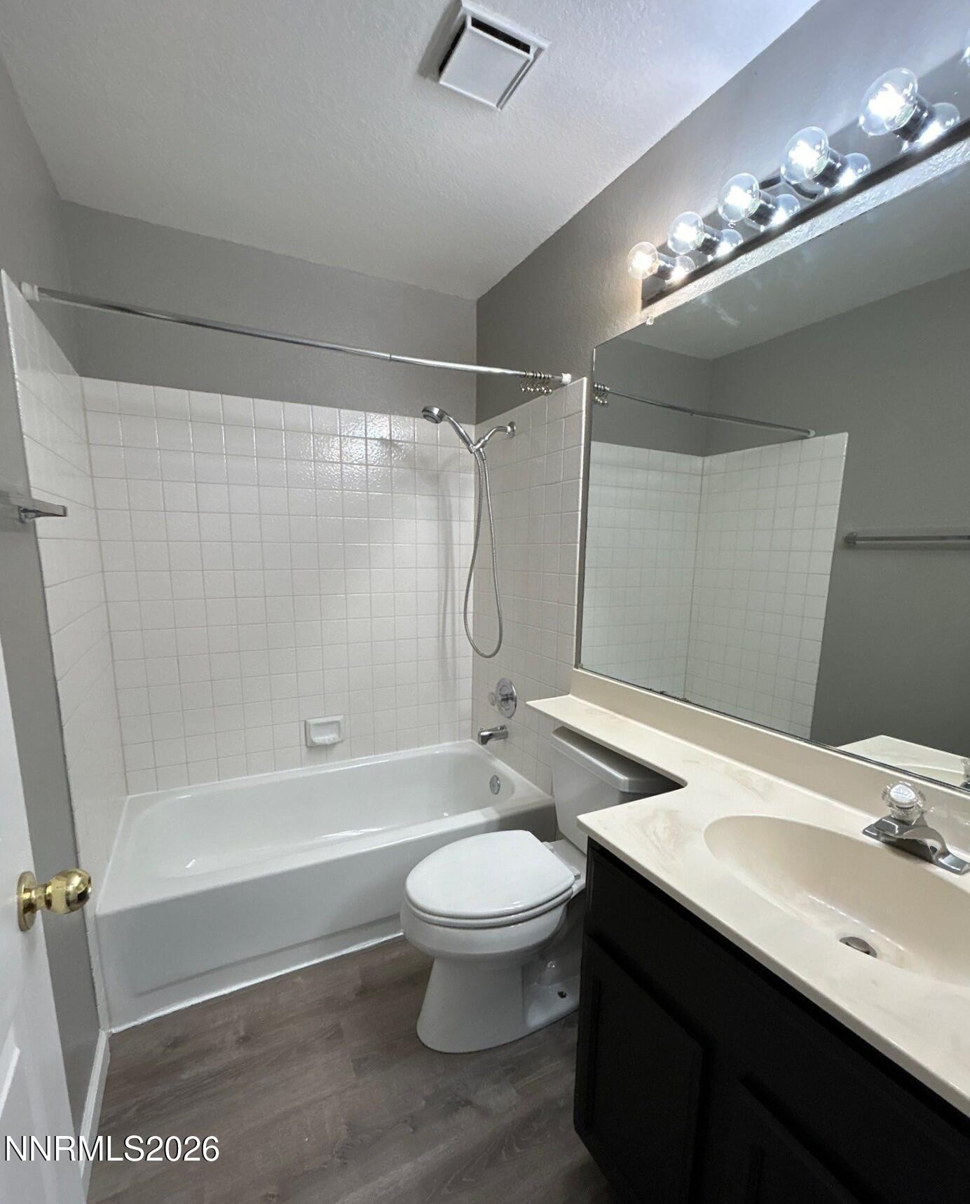 4771 Amber Hill Lane Reno, NV 89523 - Photo 10 of 20 a bathroom with a sink a toilet and a large mirror