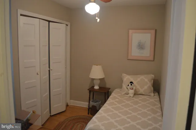 a bedroom with a bed and a lamp on the table