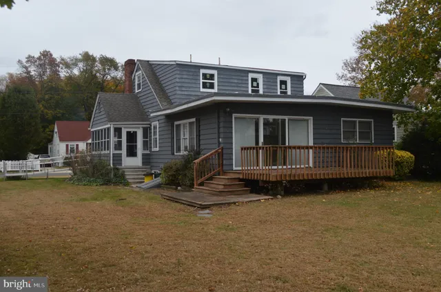a front view of a house with a garden and deck