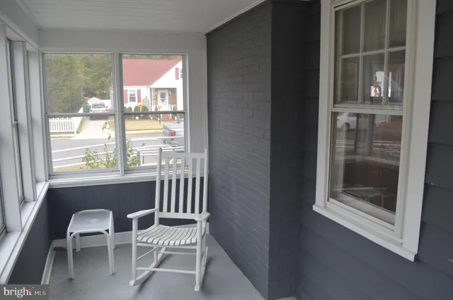 a view of a dining room with chairs and chandelier