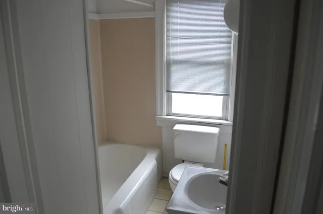 a bathroom with a toilet and bathtub