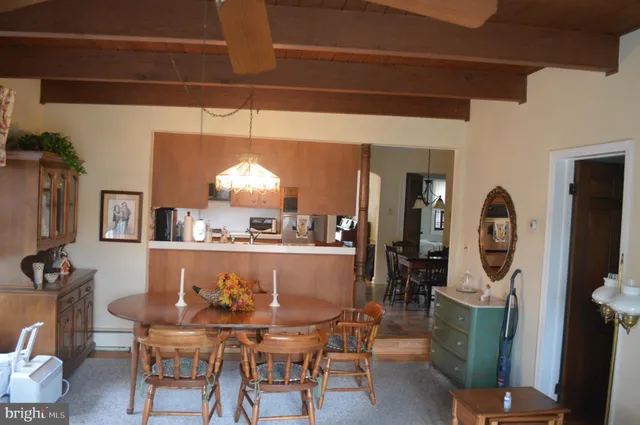 a view of a dining room with furniture and chandelier