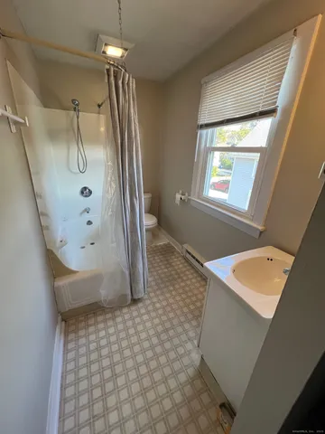 a bathroom with a shower and a sink